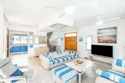 a living room with a couch and a tv at Villa Elliana by Ezoria Villas in Protaras