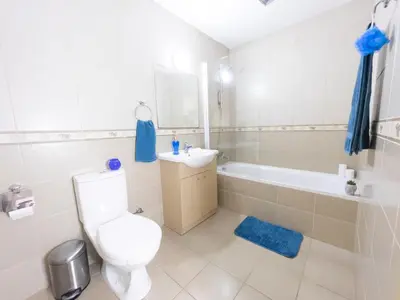 a bathroom with a toilet and a sink and a tub at Pandora Holiday Apartment Ayia Napa in Ayia Napa