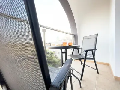 a table and chairs in a room with a window at Pandora Holiday Apartment Ayia Napa in Ayia Napa
