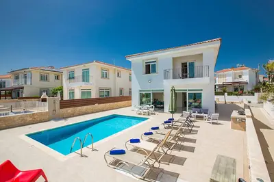 a villa with a swimming pool and lounge chairs at Villa Mesogeios ME16 in Protaras