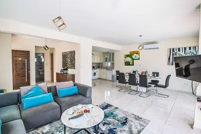 a living room with a couch and a table at Villa Mesogeios ME16 in Protaras