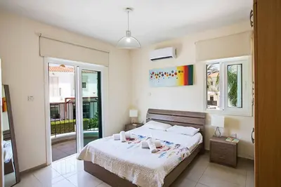 a bedroom with a bed with two stuffed animals on it at Villa Mesogeios ME16 in Protaras