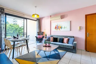 a living room with a couch and a table at Freya 1-Bedroom Apartment in Larnaca in Larnaka