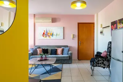 a living room with a couch and a table at Freya 1-Bedroom Apartment in Larnaca in Larnaka