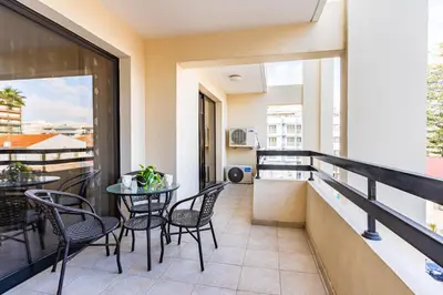 a balcony with chairs and a table on a building at Freya 1-Bedroom Apartment in Larnaca in Larnaka