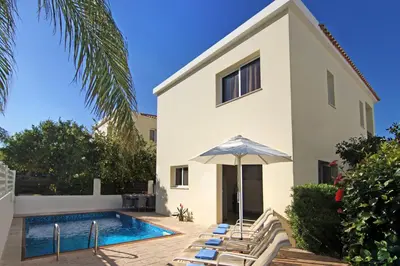 a villa with a swimming pool and a house at Villa Clara in Protaras