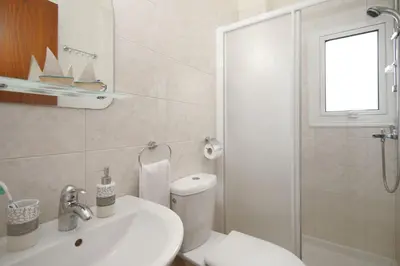 a bathroom with a sink and a toilet and a shower at Villa Clara in Protaras