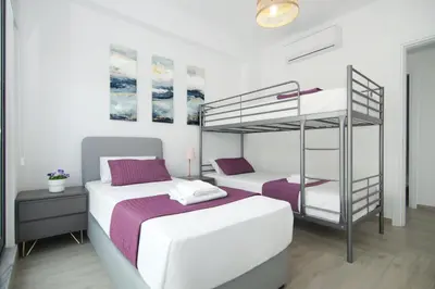 a bedroom with two beds and a bunk bed at Villa Amity in Protaras
