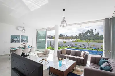 a living room with a couch and a tv and a table at Olivine Pearl OL21 in Protaras