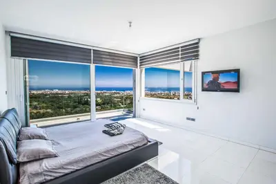 a bedroom with a bed and a large window at Villa Pallas KO1 in Protaras