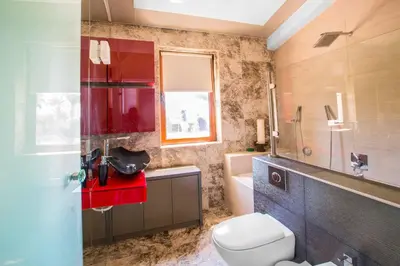 a bathroom with a toilet and a sink and a mirror at Villa Nyx in Protaras