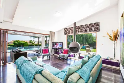 a living room with a large couch and a large window at Villa Nyx in Protaras