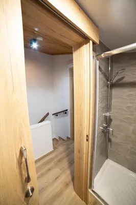 a bathroom with a shower and a glass door at Archontiko Adamou in Kyperounda