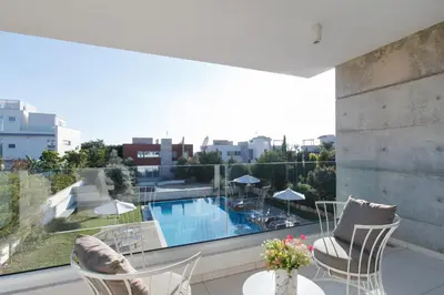 a balcony with a view of a swimming pool at Vivo Mare Beachfront Villas - Emerald in Ayia Napa