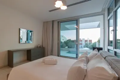 a living room with a couch and a large window at Vivo Mare Beachfront Villas - Emerald in Ayia Napa