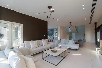 a living room with white couches and a table at Vivo Mare Beachfront Villas - Emerald in Ayia Napa