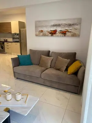 a living room with a couch and a table at Cosmos Residence in Paralimni