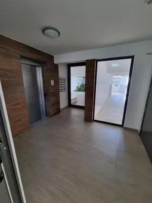 an empty room with glass doors and wooden floors at Cosmos Residence in Paralimni
