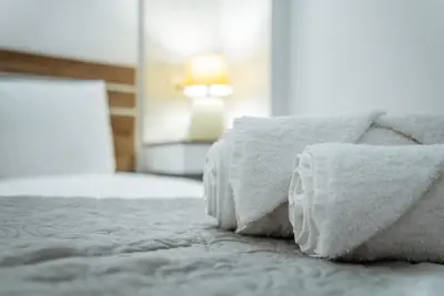 a bed with two pillows sitting on top of it at Tsolias Apartments in Protaras