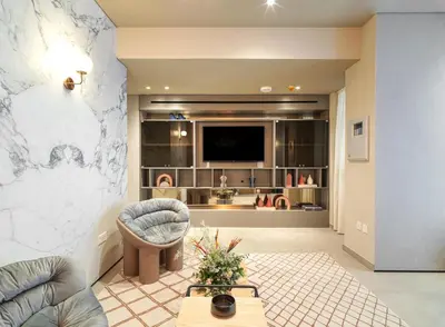 a living room with a marble wall at LIV Mackenzie Beach Suites Larnaca ADULTS ONLY in Larnaka
