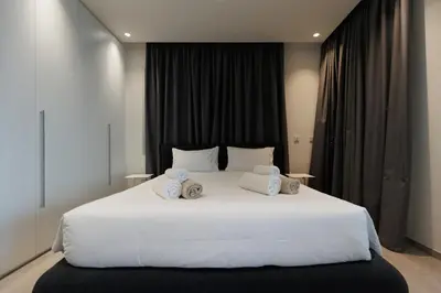 a bedroom with a large white bed with two pillows at Napa Hills Seaview Villas - Iris in Ayia Napa