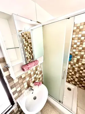 a bathroom with a sink and a shower and a toilet at Harbour Seaside Escape in Ayia Napa