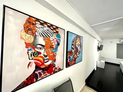 a hallway with three paintings on the wall at Harbour Seaside Escape in Ayia Napa