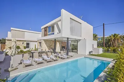 a house with a swimming pool in front of a house at Nissi Kube KB1 in Ayia Napa