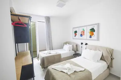 a hotel room with two beds and a window at Nissi Kube KB1 in Ayia Napa