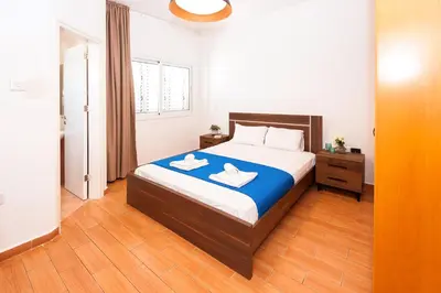 a bedroom with a bed with two towels on it at Villa White Star - 100m from Serena Beach in Protaras