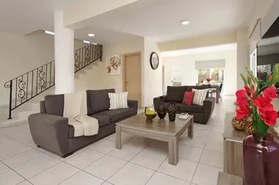 a living room with two couches and a coffee table at Nissi Dreams Villa in Ayia Napa