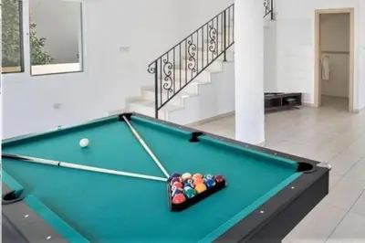 a pool table in a room with afits at Nissi Dreams Villa in Ayia Napa