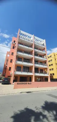 a large apartment building with a sign in front of it at STEFARIS PROPERTIES 