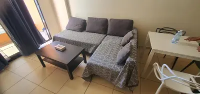 a small room with a bed and a table and a window at STEFARIS PROPERTIES 
