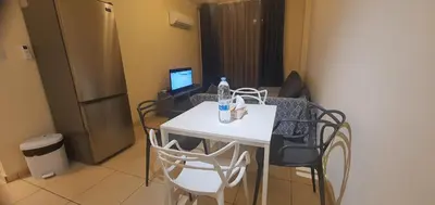 a small kitchen with a white table and chairs at STEFARIS PROPERTIES 