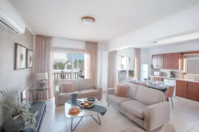a living room with a couch and a table at Blue Crystal Seaview in Protaras