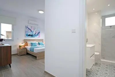 a bedroom with a bed and a bathroom at Villa Catalina in Ayia Napa