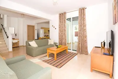 a living room with a couch and a table at Villa Mandy in Protaras