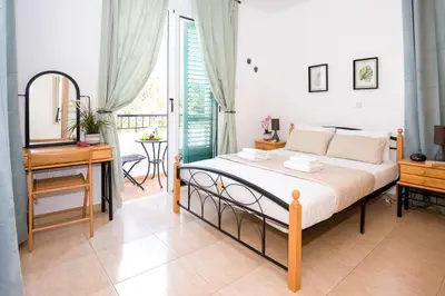 a bedroom with a bed and a desk and a mirror at Villa Mandy in Protaras