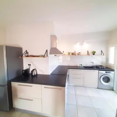 a white kitchen with a sink and a dishwasher at Sea Breeze Central, 2bed in Limassol