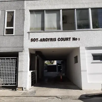 a building with a tunnel with a sign that reads obj arrays court no at Sea Breeze Central, 2bed in Limassol