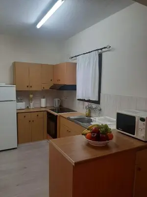 a kitchen with a bowl of fruit on a counter at Klimataria B2 in Pissouri