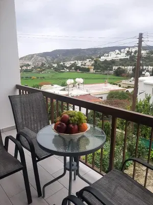 a bowl of fruit on a table on a balcony at Klimataria B2 in Pissouri