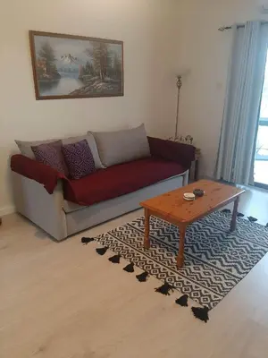 a living room with a couch and a coffee table at Klimataria B2 in Pissouri