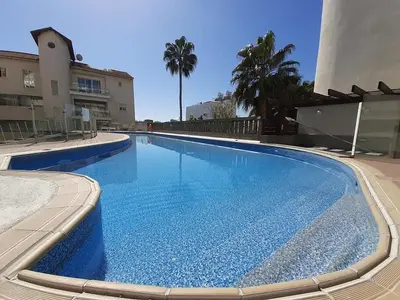a large blue swimming pool next to a building at Anamor apartment 408 in Larnaka