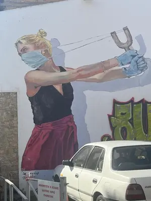 a painting of a woman on a wall at Anamor apartment 408 in Larnaka