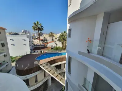 a view of a building with a swimming pool at Anamor apartment 408 in Larnaka