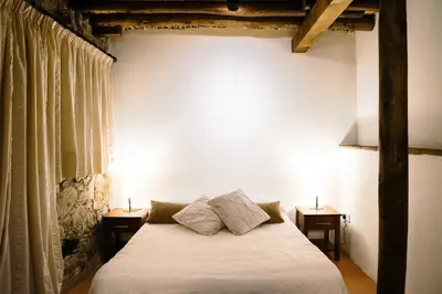 a bedroom with a white bed with two night stands at Archontiko Rousias in Nicosia