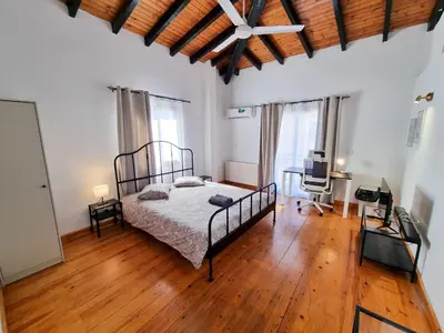 a bedroom with a bed and a desk in it at Mountains Retreat Rooms & Suites in Ayios Theodhoros