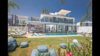 a large house with a swimming pool in front of it at Protaras Olivine Villa Ol3 in Protaras